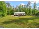 Expansive backyard surrounded by lush trees, offering a private and serene setting at 180 E Ranchette Rd, Temple, GA 30179