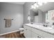 Bathroom featuring double vanity, granite countertops, and wood-look flooring at 180 E Ranchette Rd, Temple, GA 30179