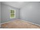 Bedroom with carpet, a window and gray painted walls at 180 E Ranchette Rd, Temple, GA 30179