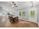 Bright dining area with wood floors, modern lighting, and an adjacent kitchen at 180 E Ranchette Rd, Temple, GA 30179