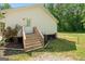 Home exterior featuring steps up to the back door and mature landscaping at 180 E Ranchette Rd, Temple, GA 30179