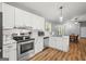 Modern kitchen featuring white cabinets, granite countertops, and stainless steel appliances at 180 E Ranchette Rd, Temple, GA 30179