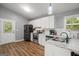 Well-lit kitchen with white cabinets, granite countertops, and stainless steel appliances at 180 E Ranchette Rd, Temple, GA 30179