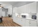 Well-lit kitchen featuring white cabinets, granite countertops, and stainless steel appliances at 180 E Ranchette Rd, Temple, GA 30179
