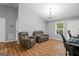 Comfortable living room featuring wood floors, neutral walls, and modern lighting at 180 E Ranchette Rd, Temple, GA 30179