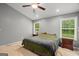 Main bedroom with natural light, ceiling fan, and wood floors at 180 E Ranchette Rd, Temple, GA 30179
