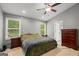 Main bedroom with natural light, ceiling fan, and ensuite bathroom access at 180 E Ranchette Rd, Temple, GA 30179