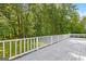 Exterior back deck with white painted wood and natural wooded view at 295 Merrydale Dr, Fayetteville, GA 30215