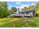 Stunning back exterior showcasing a spacious deck perfect for outdoor entertainment and relaxation at 295 Merrydale Dr, Fayetteville, GA 30215