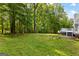 Expansive, grassy backyard featuring mature trees, ideal for outdoor activities and relaxation at 295 Merrydale Dr, Fayetteville, GA 30215