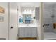 Bathroom featuring a white vanity, mirror, and accessible shower with a built in folding seat at 295 Merrydale Dr, Fayetteville, GA 30215