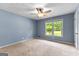 Bright bedroom with a ceiling fan and view of the outdoors from the window at 295 Merrydale Dr, Fayetteville, GA 30215