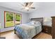 Bedroom featuring a bed, ceiling fan, and a large window offering plenty of natural light at 295 Merrydale Dr, Fayetteville, GA 30215
