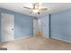 Carpeted bedroom with painted blue walls and white doors and trim at 295 Merrydale Dr, Fayetteville, GA 30215