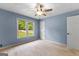 Bedroom featuring blue walls, carpet, and a window with natural light at 295 Merrydale Dr, Fayetteville, GA 30215