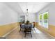 Bright dining room featuring a classic table set, decorative lighting, and natural light streaming through the windows at 295 Merrydale Dr, Fayetteville, GA 30215