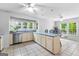 Spacious open-concept kitchen flowing into breakfast nook and tile flooring throughout with stainless steel dishwasher at 295 Merrydale Dr, Fayetteville, GA 30215