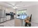 Charming kitchen with stainless steel appliances, white cabinetry, tile backsplash, and an adjacent breakfast bar at 295 Merrydale Dr, Fayetteville, GA 30215