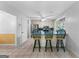 Open kitchen layout with breakfast bar, stainless appliances, white cabinets, and tile flooring throughout at 295 Merrydale Dr, Fayetteville, GA 30215