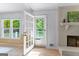 Bright living room with fireplace and french doors to the exterior at 295 Merrydale Dr, Fayetteville, GA 30215