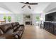 Cozy living room featuring a ceiling fan, brick fireplace, and comfortable seating at 295 Merrydale Dr, Fayetteville, GA 30215