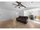 Open-concept living room featuring hardwood floors, ceiling fan, and comfortable seating at 295 Merrydale Dr, Fayetteville, GA 30215