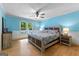 Comfortable bedroom with hardwood floors, blue walls, and a large window, providing natural light and a cozy ambiance at 295 Merrydale Dr, Fayetteville, GA 30215