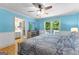 Inviting bedroom with blue walls, hardwood floors, ceiling fan, and natural light, creating a relaxing retreat at 295 Merrydale Dr, Fayetteville, GA 30215