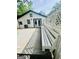 The back patio features a built-in bench, white latticework and leads to the double doors at 2502 Barge Sw Rd, Atlanta, GA 30331