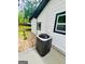 View of the home's exterior showing the HVAC unit, landscaping, and black-trimmed windows at 2502 Barge Sw Rd, Atlanta, GA 30331