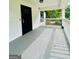 Spacious front porch features a secure entry door and ample space for outdoor seating at 2502 Barge Sw Rd, Atlanta, GA 30331