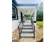 Inviting covered front porch with freshly painted stairs and elegant railings, enhancing curb appeal at 2502 Barge Sw Rd, Atlanta, GA 30331
