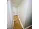 Hallway features laminate flooring and neutral paint, leading to a bright doorway at 2502 Barge Sw Rd, Atlanta, GA 30331