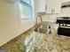 Close-up of the granite countertop and stainless steel sink in this updated kitchen at 2502 Barge Sw Rd, Atlanta, GA 30331