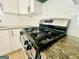 Updated kitchen with stainless steel gas range and sleek granite countertops at 2502 Barge Sw Rd, Atlanta, GA 30331