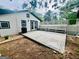 Back patio features concrete flooring, white lattice, and built-in bench seating at 2502 Barge Sw Rd, Atlanta, GA 30331