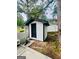 Exterior shot of a white storage shed with a black door, matching the home's design at 2502 Barge Sw Rd, Atlanta, GA 30331