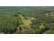 Expansive aerial view showcasing the home nestled amidst a dense forest landscape at 9511 High Point Rd, Villa Rica, GA 30180