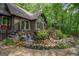 Backyard featuring a rock waterfall flowing into a garden area, surrounded by lush greenery at 9511 High Point Rd, Villa Rica, GA 30180