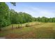 Sprawling backyard featuring mature trees and a well-maintained fenced lawn at 9511 High Point Rd, Villa Rica, GA 30180