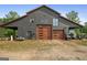 Spacious barn with modern wood paneled doors, ample storage, and attached covered parking area at 9511 High Point Rd, Villa Rica, GA 30180