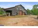 Large barn featuring modern wood doors and covered parking, perfect for equipment storage and projects at 9511 High Point Rd, Villa Rica, GA 30180