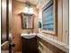 Bathroom boasts wood accents, decorative lighting, mirror, and wood vanity sink at 9511 High Point Rd, Villa Rica, GA 30180
