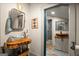 Bathroom featuring vessel sinks on wooden countertops with modern fixtures and tiled shower in the background at 9511 High Point Rd, Villa Rica, GA 30180