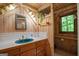 Quaint bathroom with wooden walls features a unique blue sink and bright lighting at 9511 High Point Rd, Villa Rica, GA 30180