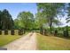 Long gravel driveway leading up to the property, with gated entrance and sprawling greenery at 9511 High Point Rd, Villa Rica, GA 30180