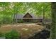 Charming home with lush green trees on a sunny day, complete with a quaint front yard at 9511 High Point Rd, Villa Rica, GA 30180