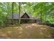 Charming home with lush green trees on a sunny day, complete with a quaint front yard at 9511 High Point Rd, Villa Rica, GA 30180