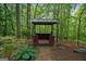 Cozy gazebo nestled in a lush, wooded setting, perfect for relaxation at 9511 High Point Rd, Villa Rica, GA 30180