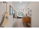 Hallway featuring musical instruments and leading to a bedroom, accented with a decorative table and lamp at 9511 High Point Rd, Villa Rica, GA 30180